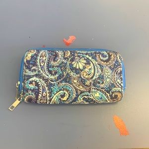 - Blue patterned wallet. Two compartments. Multiple slots for cards.